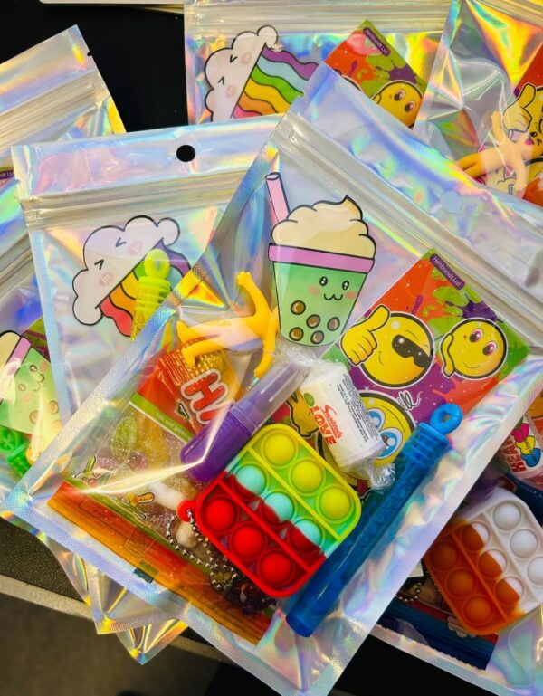 Unisex Holographic Pre Filled Party Pack comes pre-filled with a delightful assortment of sticker, fidget keyring, bubbles, vegan sweets and much more.